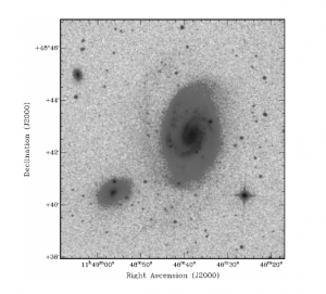 Figure 2. R band image from the DSS2 survey of the interacting galaxy pair. Enhanced contrast allows the reader to see the faint spiral arm of the larger galaxy and a dim bridge between the two.