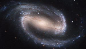 NGC 1300, a barred spiral galaxy. You can notice that there's a huge difference between the colors in the central region and on the spiral arms. Image Credit: Hubble Heritage Team, ESA, NASA.