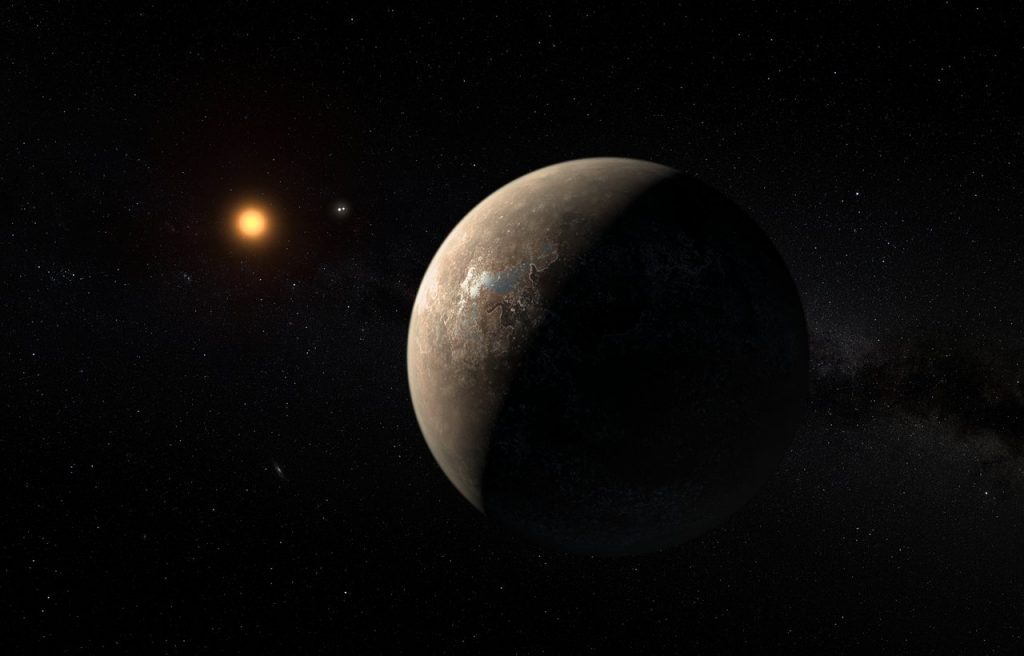 This artist’s impression shows the planet Proxima b orbiting the red dwarf star Proxima Centauri, the closest star to the Solar System. The double star Alpha Centauri AB also appears in the image between the planet and Proxima itself. Proxima b is a little more massive than the Earth and orbits in the habitable zone around Proxima Centauri, where the temperature is suitable for liquid water to exist on its surface.