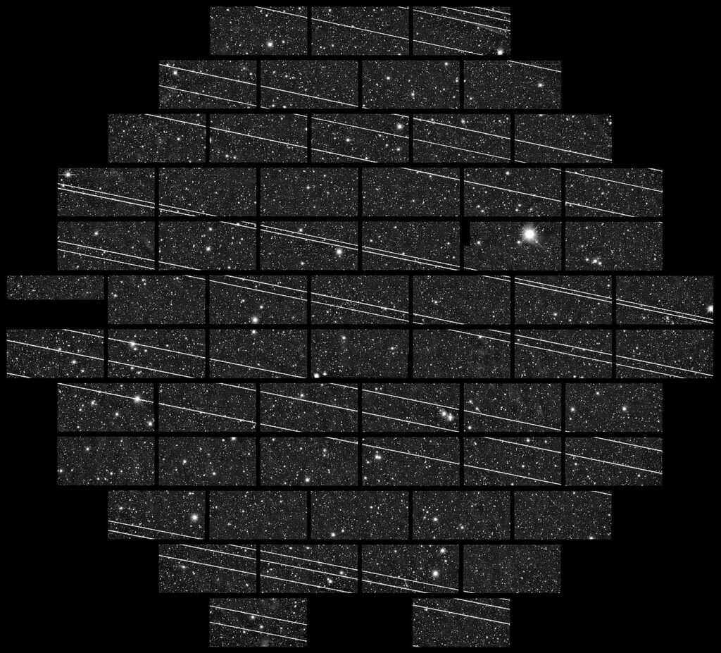 Science image of the sky showing a grid of tiled images, each with stars/galaxies in the background and streaks of light in the foreground covering the astronomical objects.