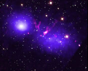 Chandra image of two merging galaxies in pink, purple, and dark blue tones.
