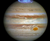 Composite image of Jupiter that combines a full-color image and far-UV Hubble observations of the aurorae at Jupiter's north pole.
