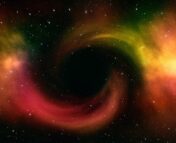 colorful gas swirls around the center of the image, where a black hole is shown, though not visible
