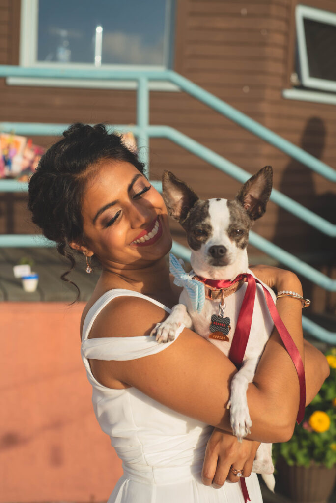 Dr. Patel hugging one of her dogs