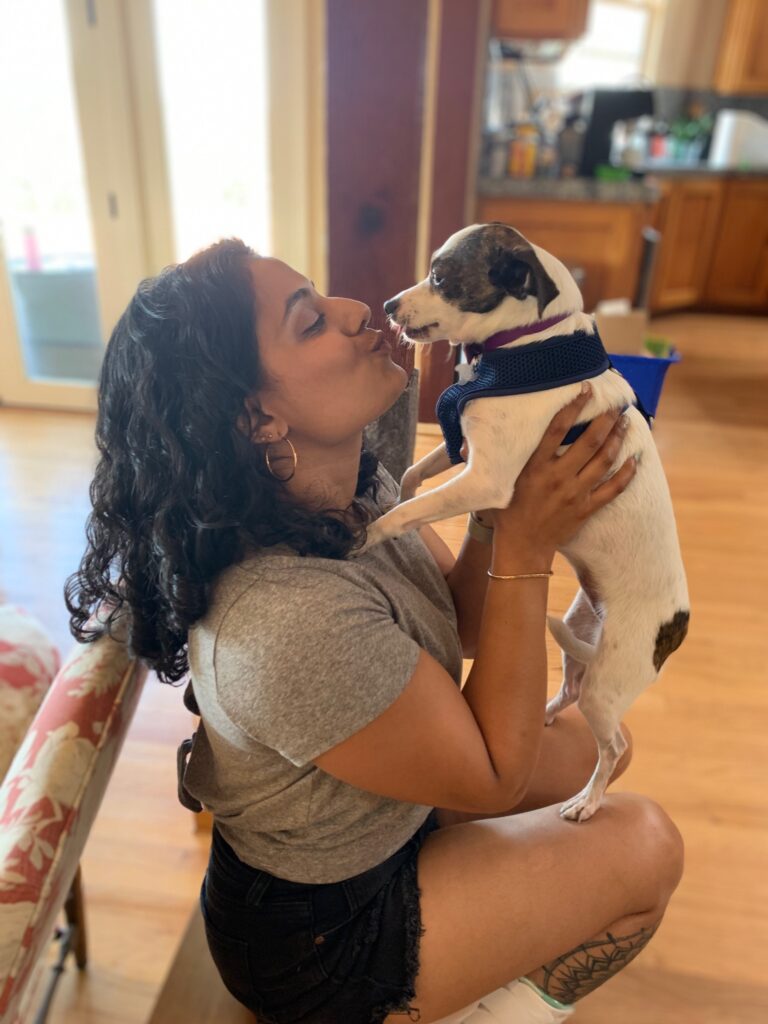 Dr. Patel giving her other dog a kiss