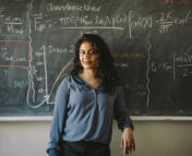 Dr. Ekta Patel standing in front of a blackboard