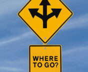Yellow street sign showing three diverging arrows with the text "Where to go?"