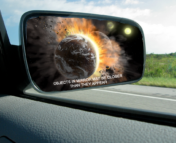 Car side mirror displaying an exoplanet collision in the blindspot