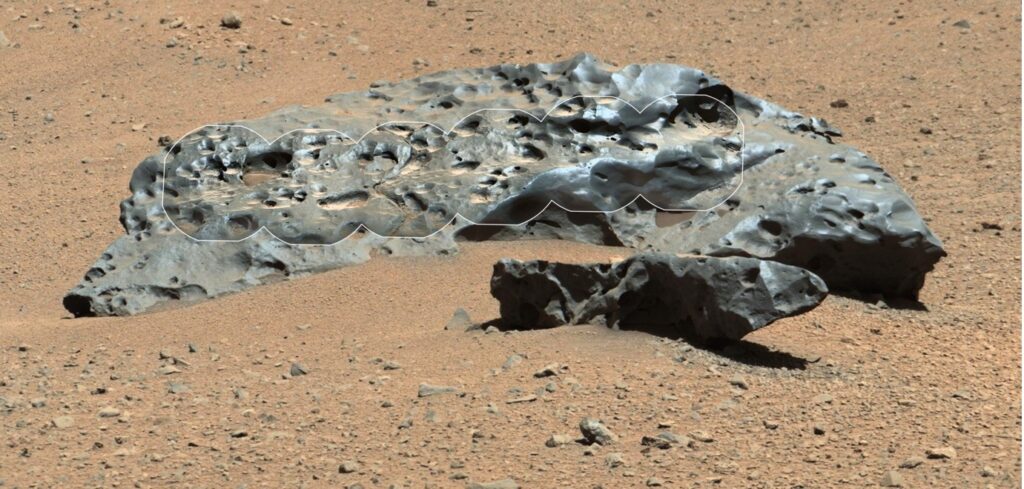 An image of the Martian meteorite, 'Lebanon.' The meteorite is large, grey, and slightly shiny.