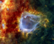 A bubble of gas and dust created by the radiation emitted during the formation of a new star.
