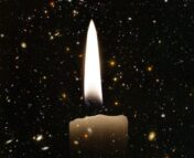 A candle is super imposed onto a background of hundreds of galaxies