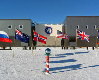 photo of the south pole, surrounded by flags