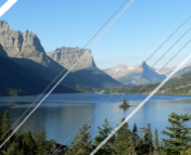 A perfectly picturesque view of a mountain, lake, and clear blue sky. The image is overlaid by several bars of white and grey of varying thicknesses, ruining the view.