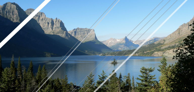 A perfectly picturesque view of a mountain, lake, and clear blue sky. The image is overlaid by several bars of white and grey of varying thicknesses, ruining the view.