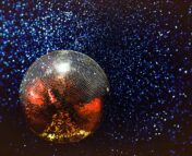 disco ball projecting spots of light over dark room