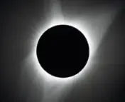 Solar eclipse -- white corona of sun visible around black circle