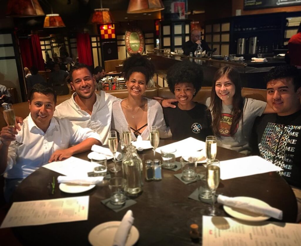 People sitting at a dining table and smiling