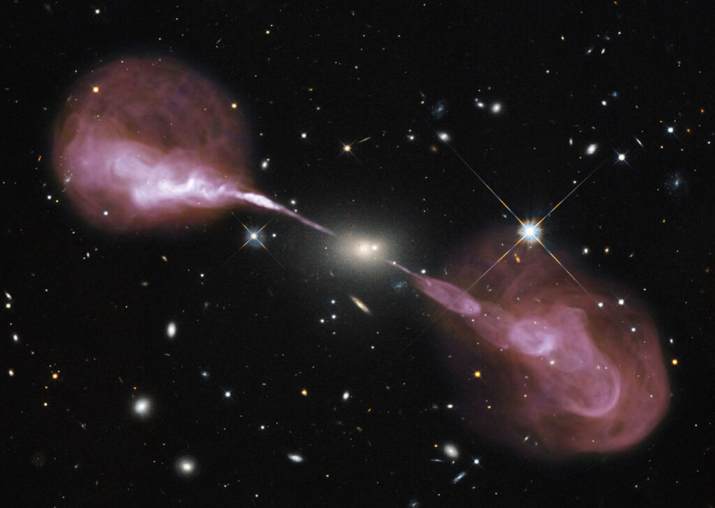 The radio galaxy Her A, a central source with two narrow outflows that end in lobes of material.
