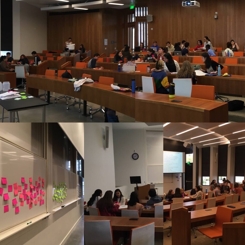 Students in a lecture hall pasting sticky notes on the board during an astro sequoia town hall