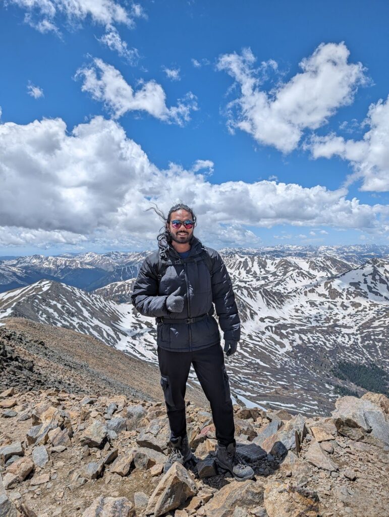 Aman on top of a mountain.