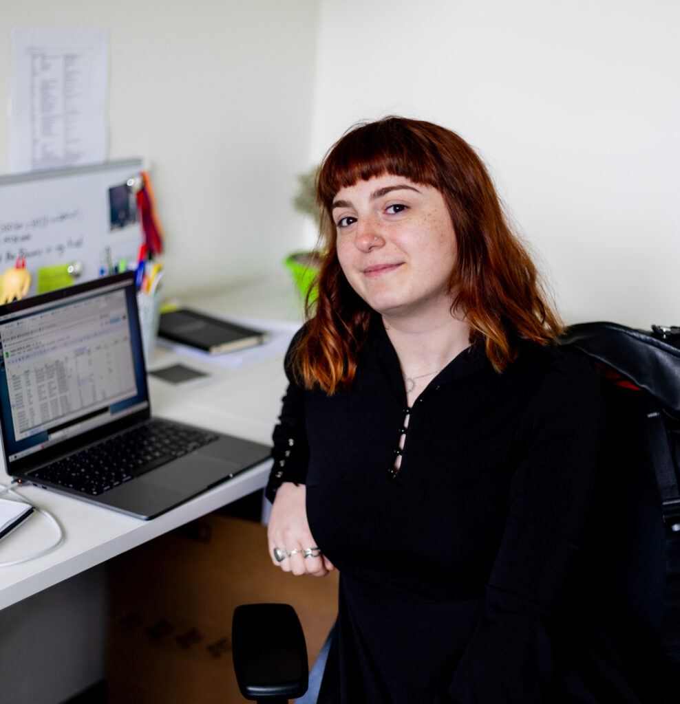 Tatevik Mkrtchyan sits at her desk, smiling at the camera. 