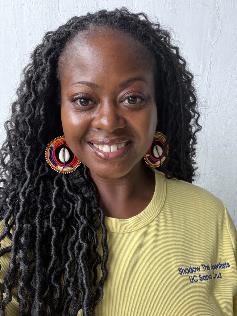 Headshot of Jameeka Marshall. She has long black, curly hair and wears red circle earrings. She wears a pale yellow t-shirt against a solid white background.