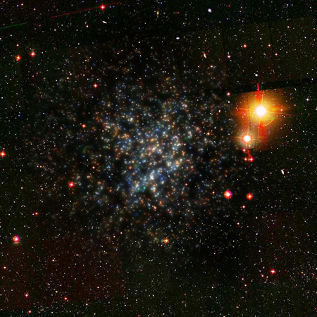 The UFD Bootes I. It appears as a clumpy mess of blue and red/orange points on a back background. Several foreground stars can be seen to the right. 